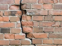 Vertical crack in brick wall